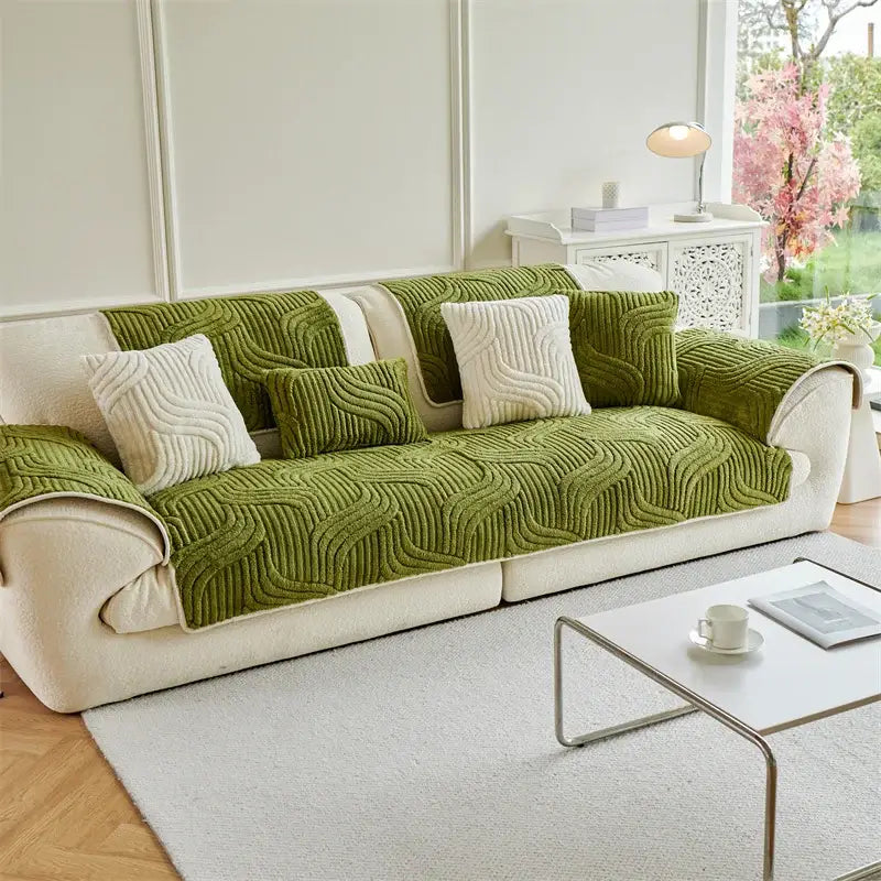Olive green quilted sofa cover with cream textured pillows featuring cream quilted wave plush design for living room use