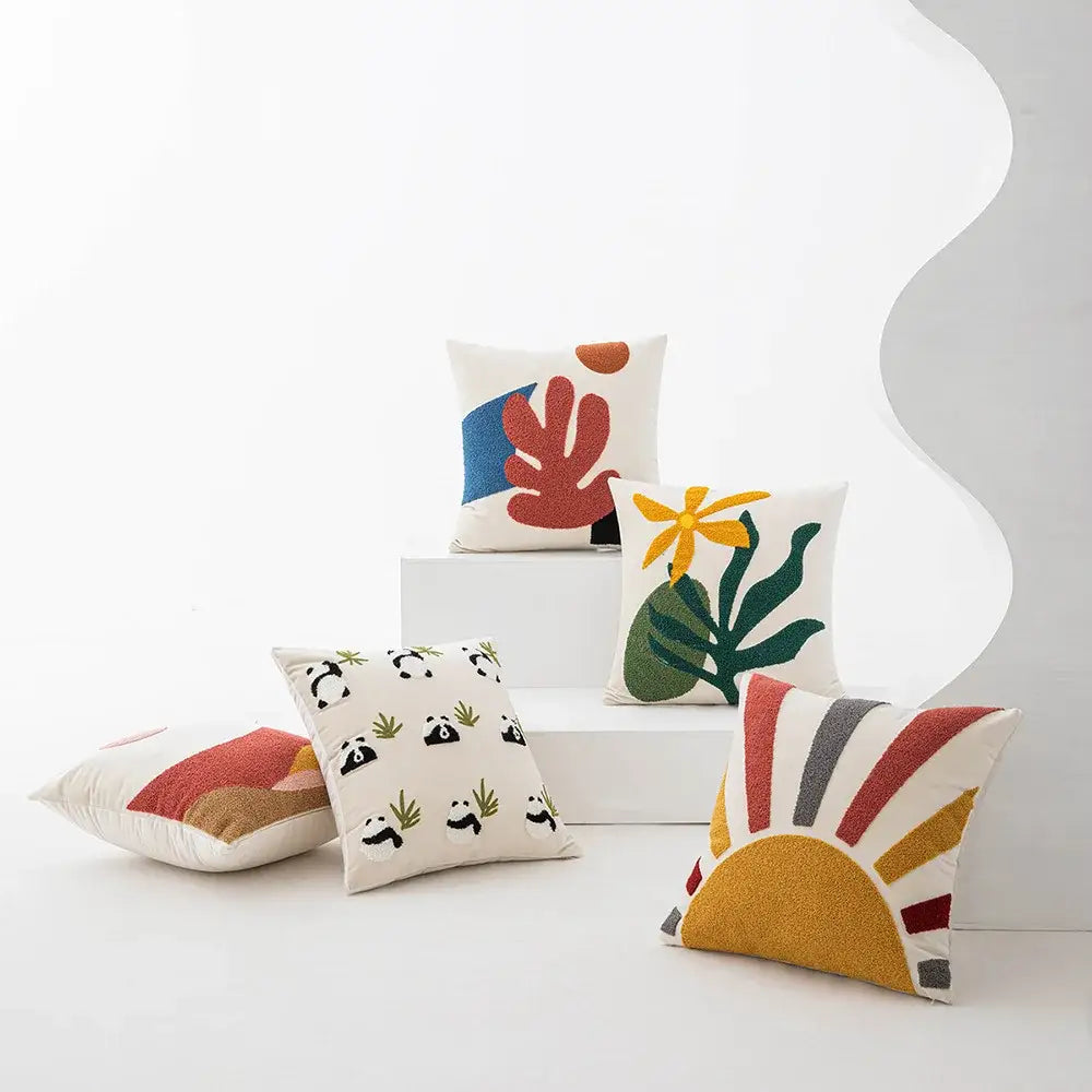 Cream white cushion cover with colorful cartoon abstract embroidery featuring leaves and sunburst decorbites design