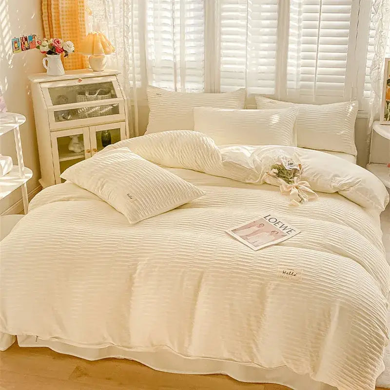 Cream ribbed bubble yarn cotton duvet cover set with a soft textured finish and subtle embroidered branding