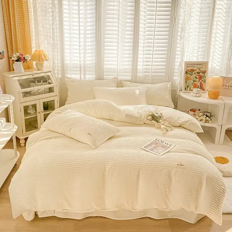 Cream ribbed bubble yarn duvet cover set in cream cotton with a soft textured finish and embroidered pillow branding