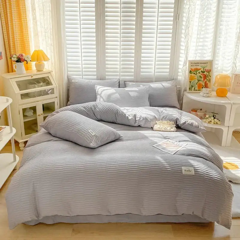 Gray ribbed cotton duvet cover set with matching pillows and soft textured finish for bedroom bedding