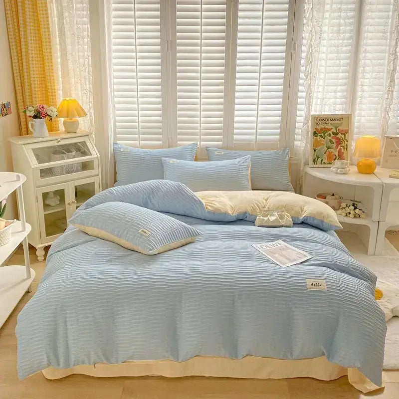 Light blue ribbed cotton duvet cover set with cream-colored accents and embroidered labels for bedroom bedding