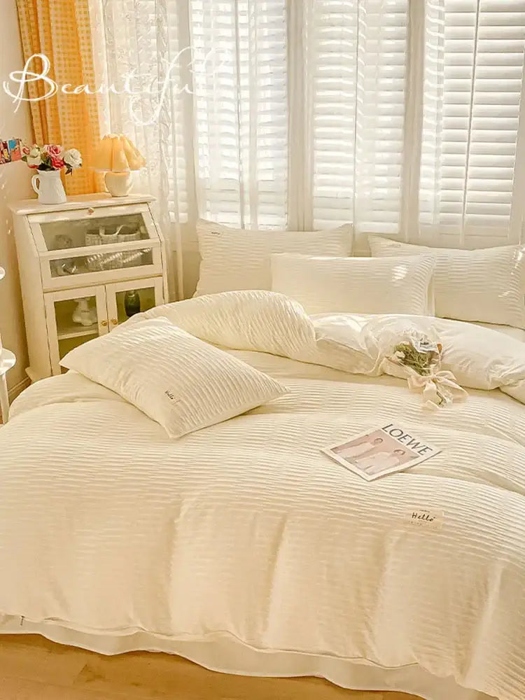 Cream ribbed bubble yarn fabric bedding set in cream color with ribbed cotton duvet and matching pillows with embroidered logo
