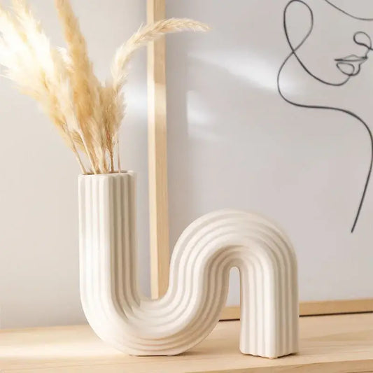 Cream ribbed geometric ceramic vase with sleek curved s shape for living room decorbites geometric decor