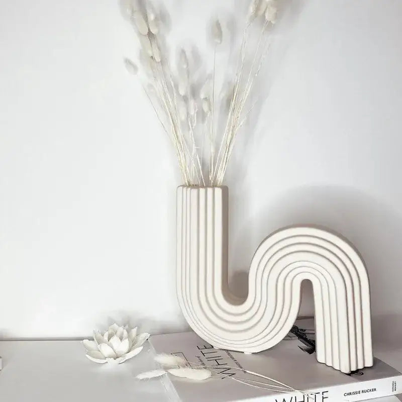 Cream ribbed geometric ceramic vase with vertical ridges and s shape design for decorbites geometric decor
