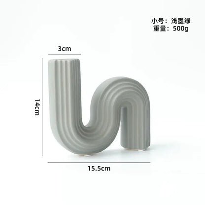 A sleek matte gray s-shaped decorbites geometric ceramic vase with vertical ridges for modern living room decor