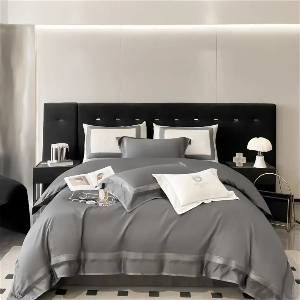 Gray satin bedding set with subtle silver piping and matching pillows on black headboard decorbites 1000tc egyptian cotton