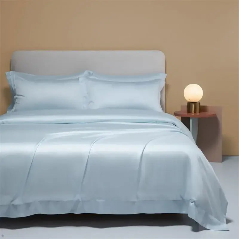 Light blue satin bedding set with matching pillows featuring a smooth glossy finish decorbites 120s natural fabric