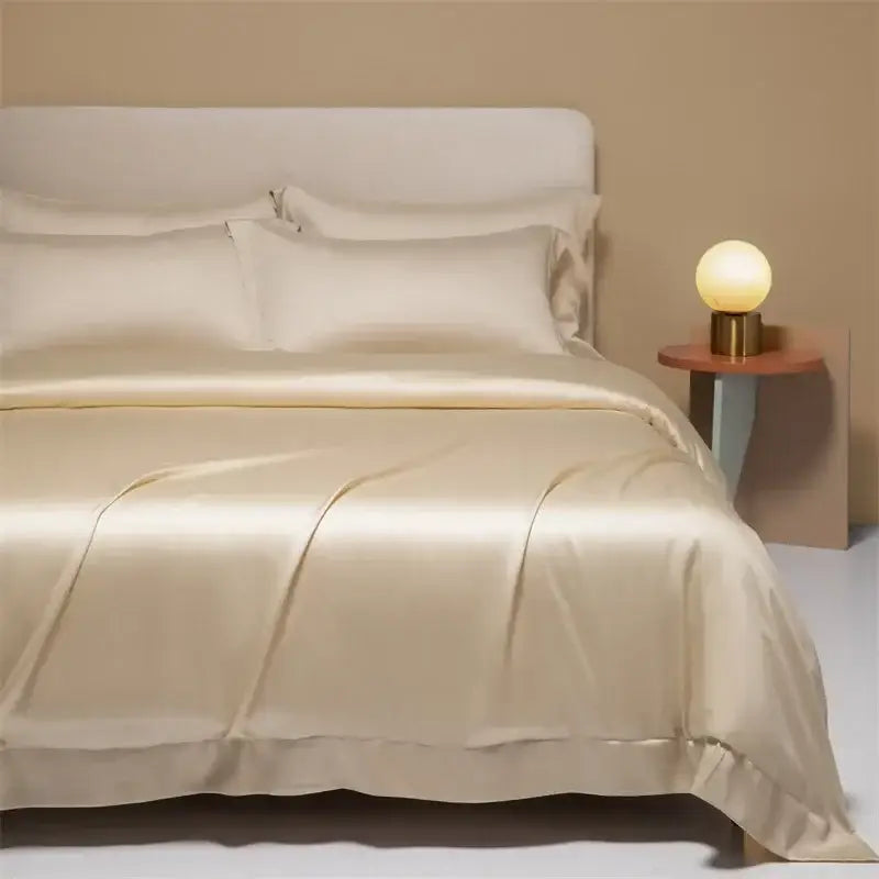 Cream satin 120s natural fabric bedding set with smooth glossy finish and subtle ruffled edges for bedroom decor
