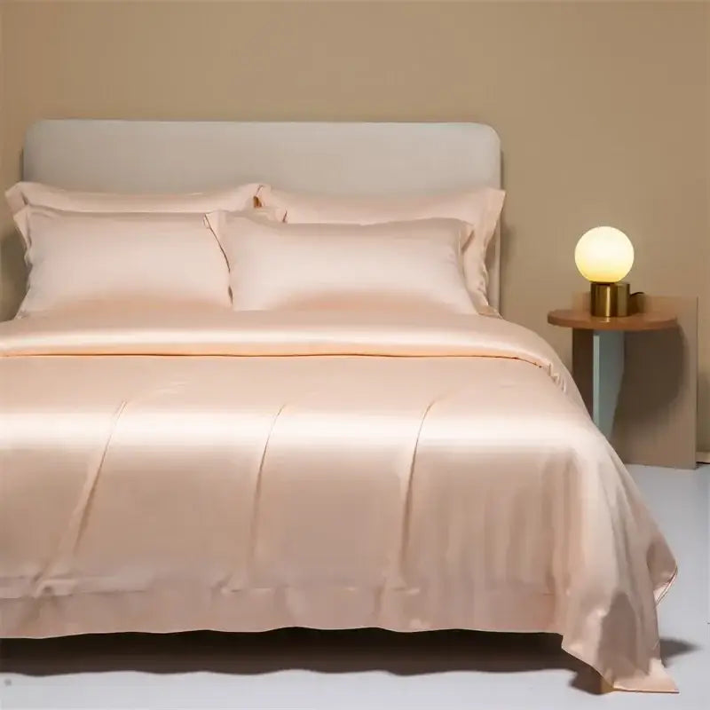 A soft peach satin duvet cover bedding set with smooth glossy finish and stitched detailing in decorbites 120s natural fabric