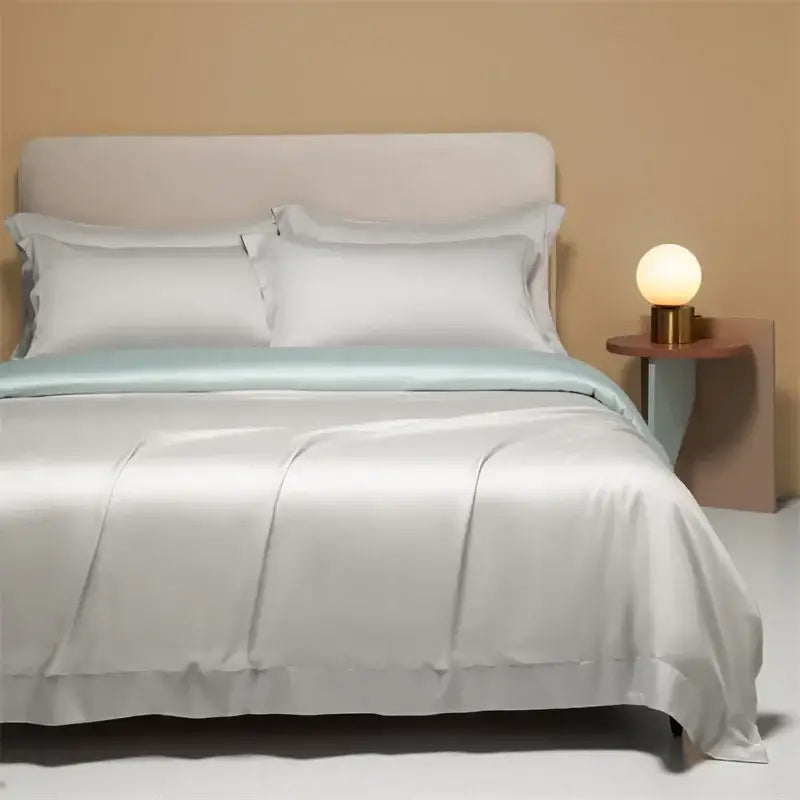 A cream satin 120s natural fabric bedding set with a sleek satin texture and subtle mint green border for cooling sheets