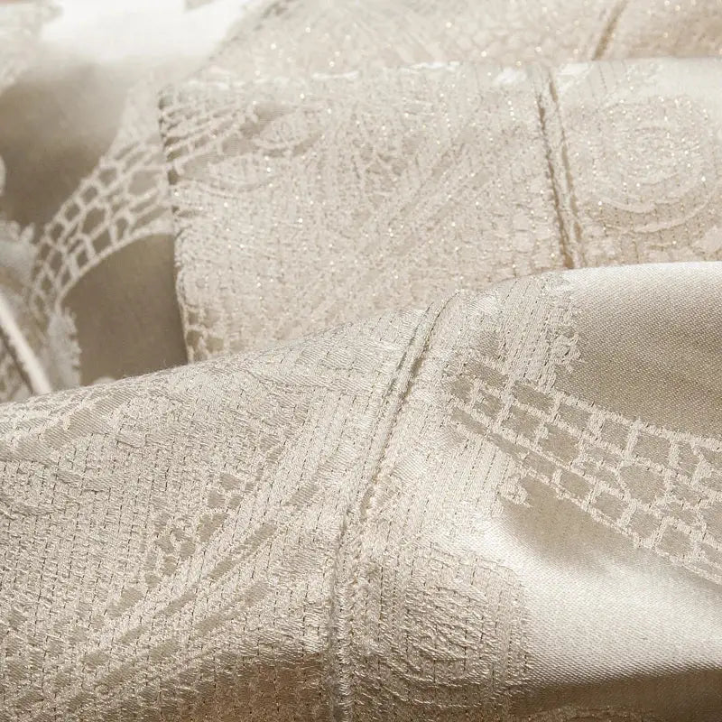 Delicate cream-colored lace fabric with intricate patterns and subtle shimmer in decorbites jacquard egyptian cotton bedding set