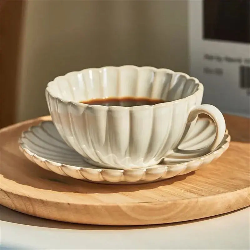 A delicate cream scalloped ceramic afternoon tea cup and saucer set for elegant ceramic afternoon tea decorbites