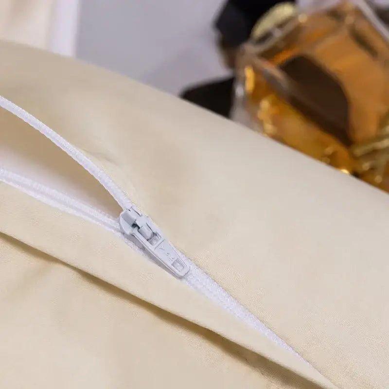 Cream-colored fabric pillowcase with white zipper closure from decorbites damask lyocell cotton bedding set