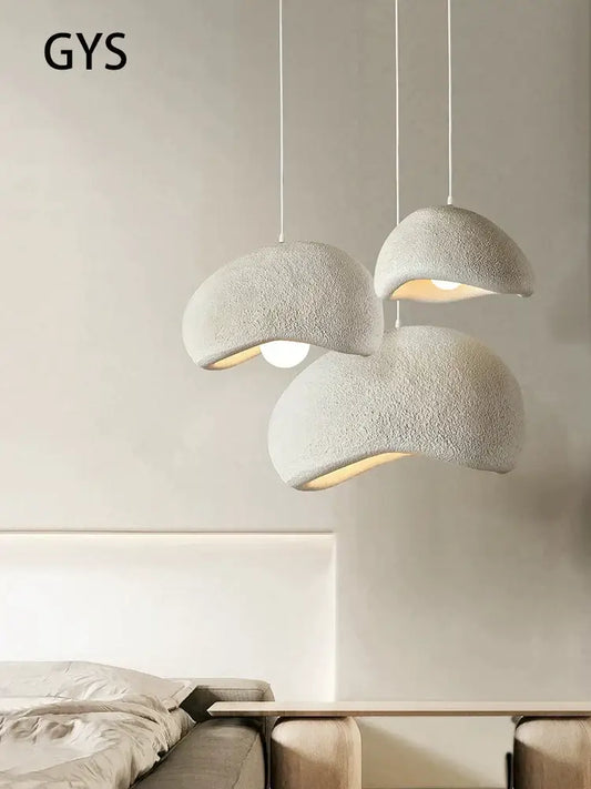 Three off-white textured cream style cloud pendant lamps hanging as dining room decorbites cream style lighting