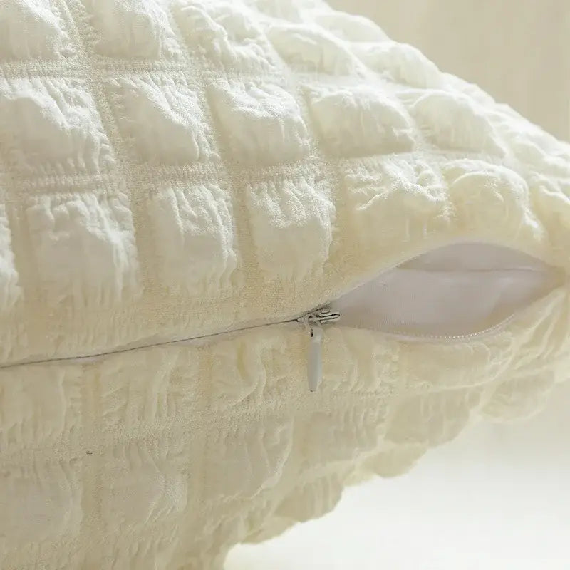 Cream-colored quilted elastic puff plaid cushion cover with a subtle grid pattern and silver zipper for living room decor