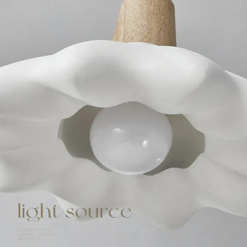 A sleek white ceramic clamshell cream style led pendant light with wooden stem for bedroom decorbites cream style use