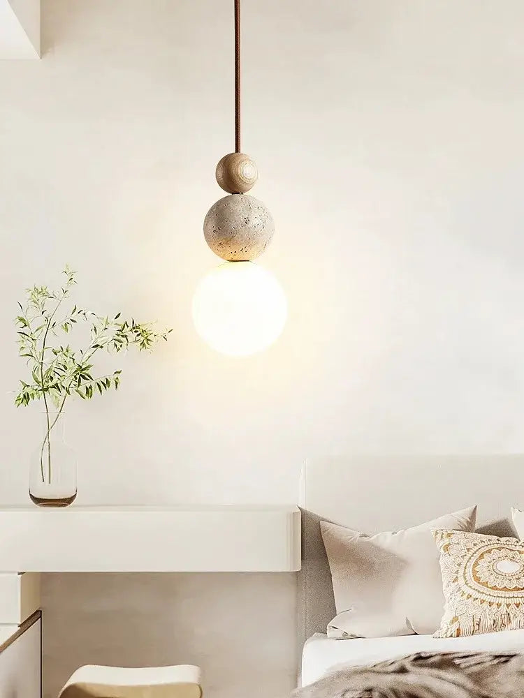 A cream style led pendant lamp with stacked concrete and wood spheres and warm glow by decorbites cream style