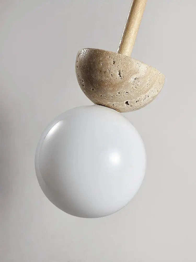 Minimalist pendant lamp with matte white glass globe, beige concrete half-dome, and wooden rod for cream style nordic decorbites
