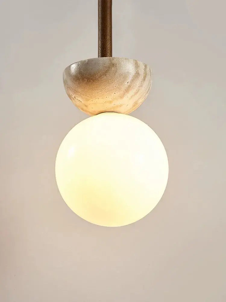 A warm glowing cream style nordic beige stone and glass pendant lamp with textured cap for bedroom decorbites decor