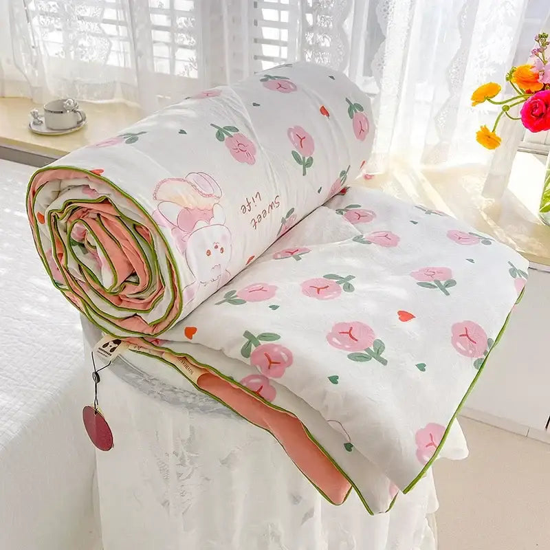 A soft white breathable double gauze quilt with pink peach pattern and coral lining for bedroom decorbites bedding