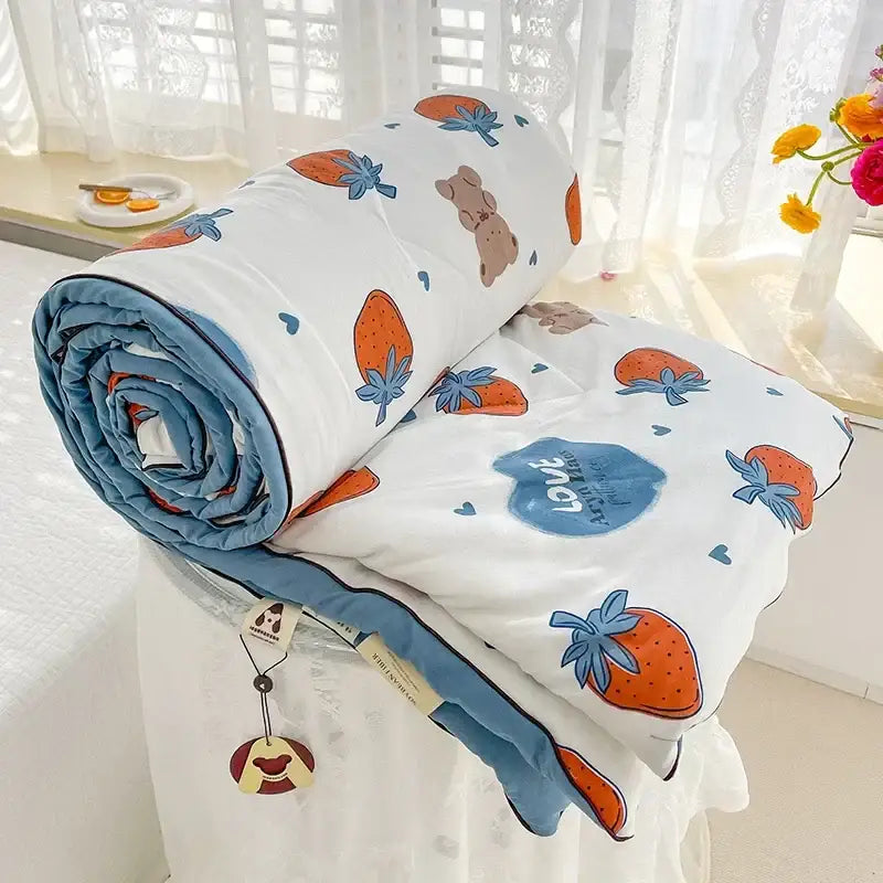 White breathable double gauze quilt with orange strawberry and brown bear prints blue trim and love design