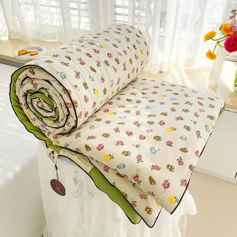 Cream teddy bear double layered soya fibre quilt with floral pattern and green piping for bedroom comforter
