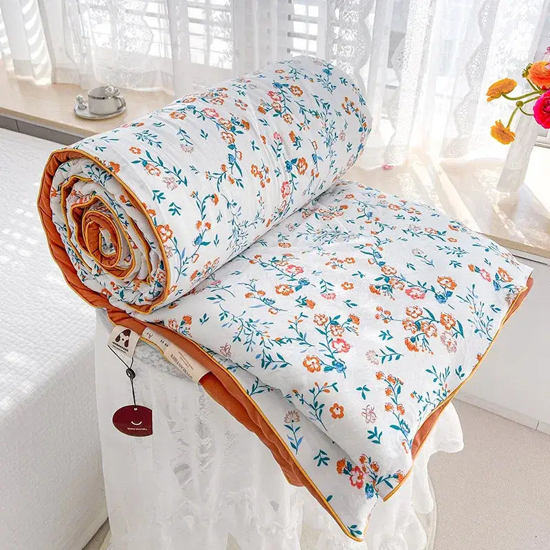 Cream teddy bear double layered soya fibre quilt with white floral pattern and orange border for bedroom comforter use