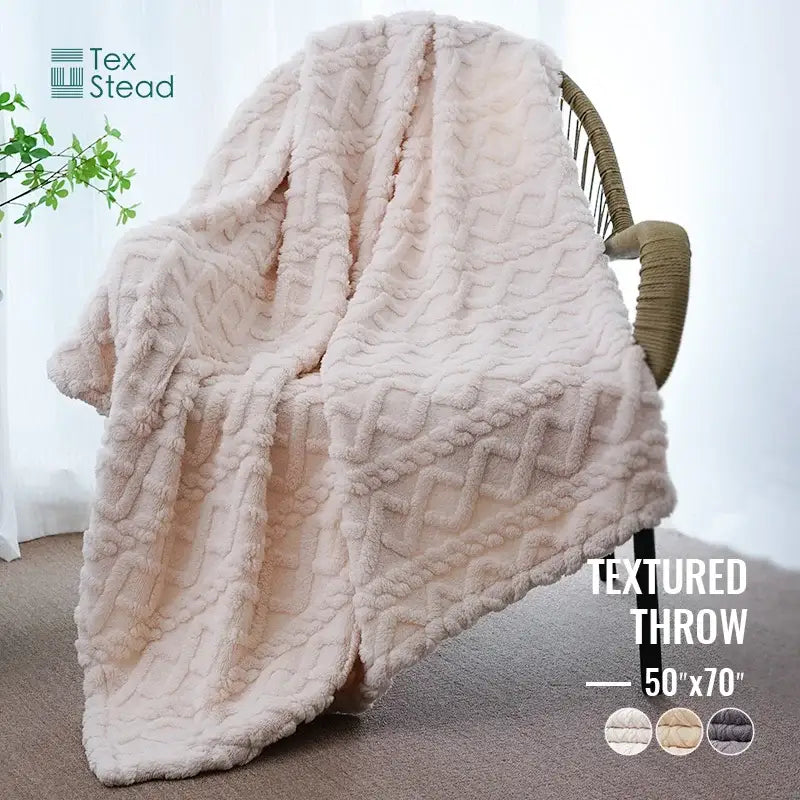 Cream textured cable knit blanket with plush tex stead pattern ideal as a decorbites cozy knit blanket for bedrooms