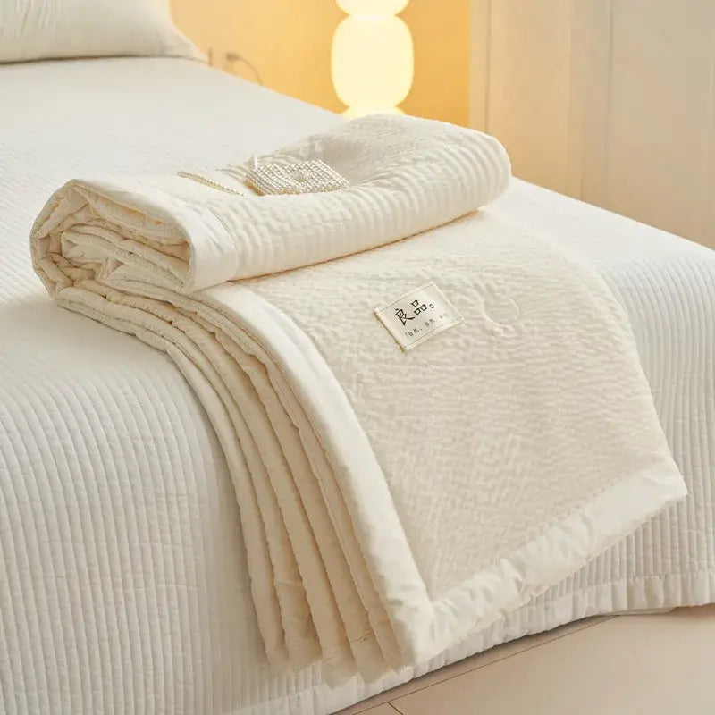 Cream textured ice cream air bubble summer quilt with quilted soft surface and ribbed stitching by Decorbites