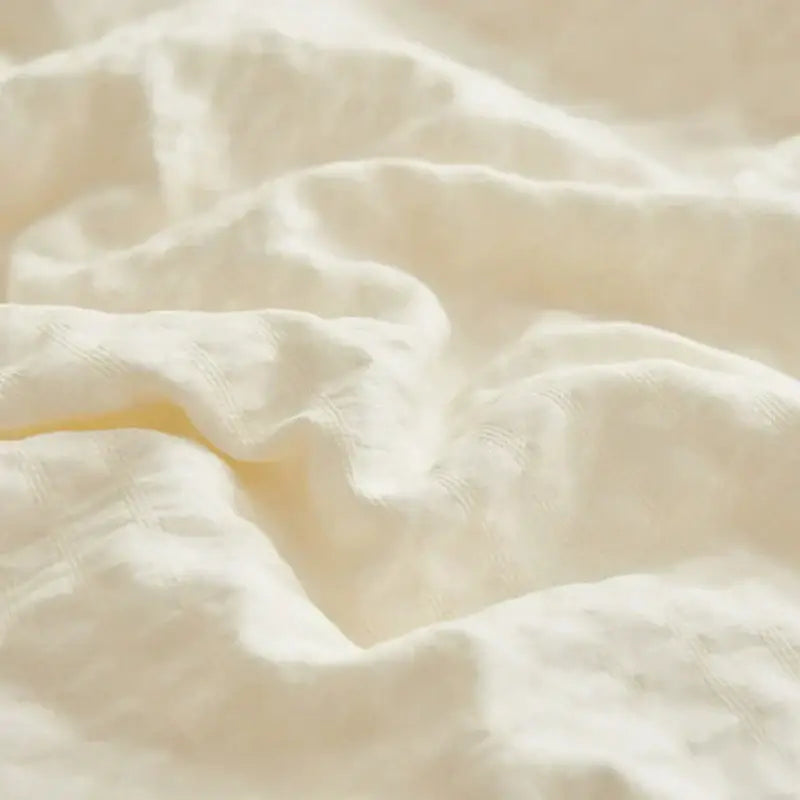 Cream textured ice cream air bubble summer quilt made of soft off-white linen fabric with subtle textured weave by decorbites