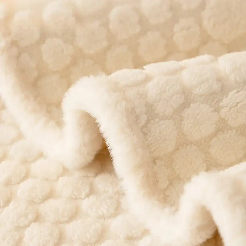 Cream textured jacquard knit plush sofa cover with soft raised circular patterns for living room use