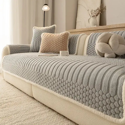 Gray textured sofa cover with plush quilted pattern and cream fleece trim made of jacquard knit fabric for living room use