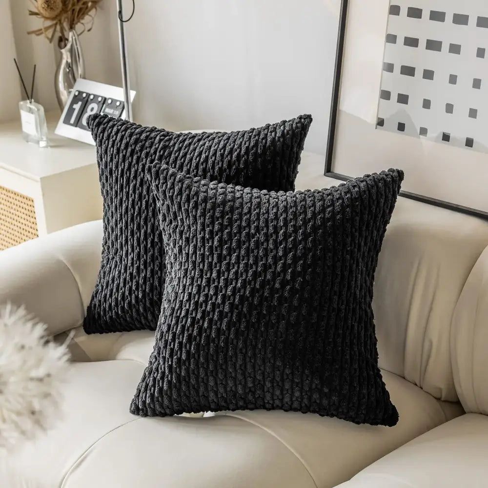 Black textured throw pillows with chunky knit pattern on cream sofa showcasing decorbites decorative pillow cover