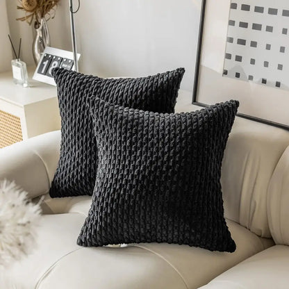 Black textured throw pillows with chunky knit pattern on cream sofa showcasing decorbites decorative pillow cover