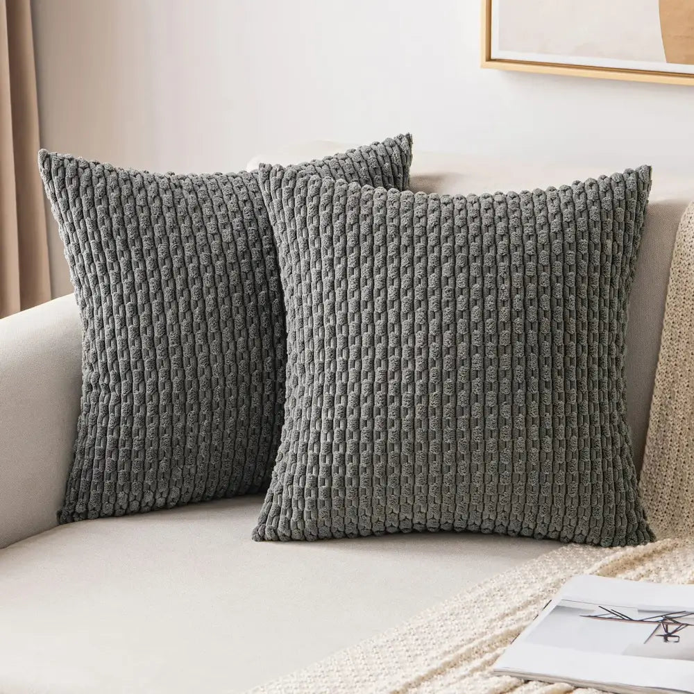 Two dark gray textured throw pillows with woven corduroy pattern on light sofa decorative pillow cover decorbites
