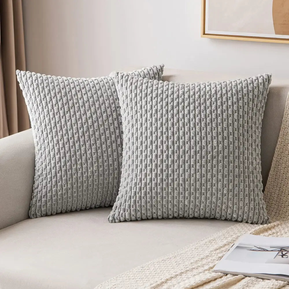 Two light gray cream textured knit decorative pillow covers on a beige sofa for living room decorbites decorative pillow