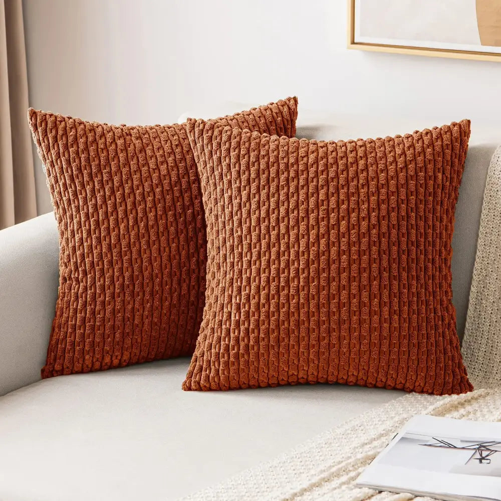 Two rust-colored corduroy throw pillows with ribbed texture complement cream knit decorative pillow cover decorbites decor