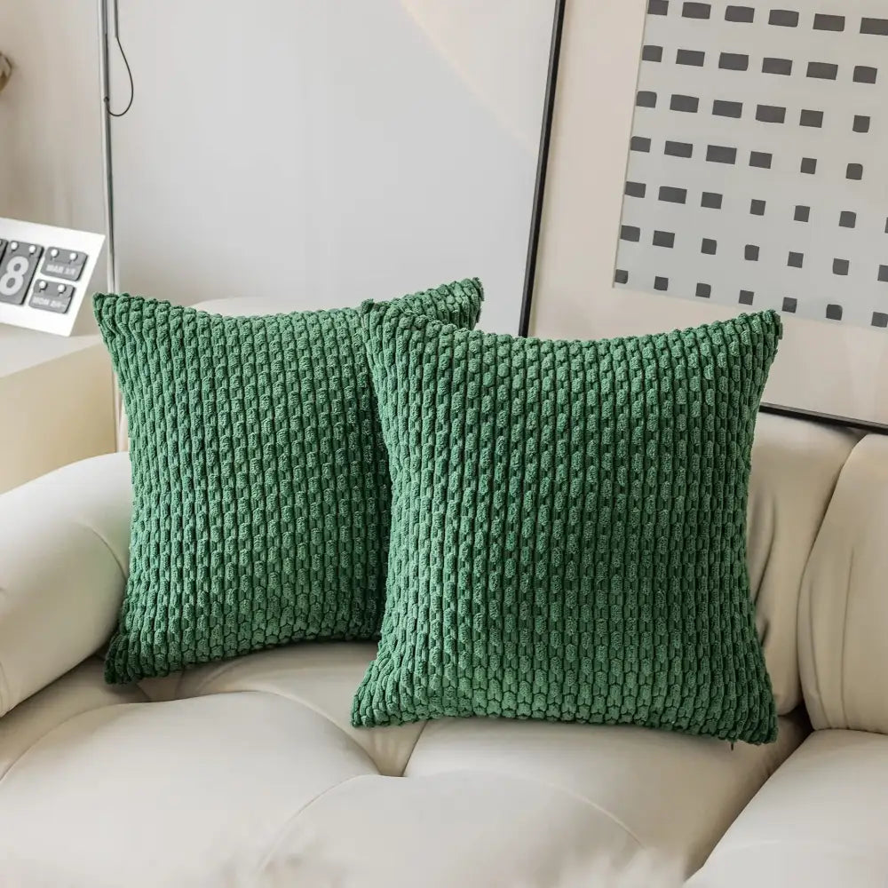 Two emerald green chunky-knit pillow covers with ribbed texture on cream sofa decorbites decorative pillow cover