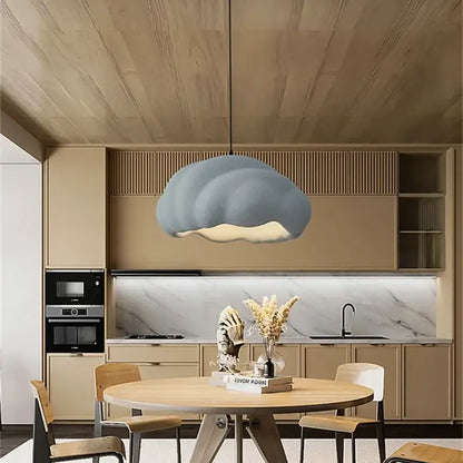 Cream wabi sabi cloud pendant chandelier in muted blue gray with matte finish hanging in a dining room decorbites cream wabi