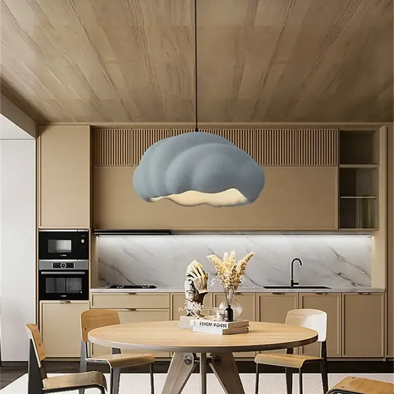 Cream wabi sabi cloud pendant chandelier in muted blue gray with matte finish hanging in a dining room decorbites cream wabi