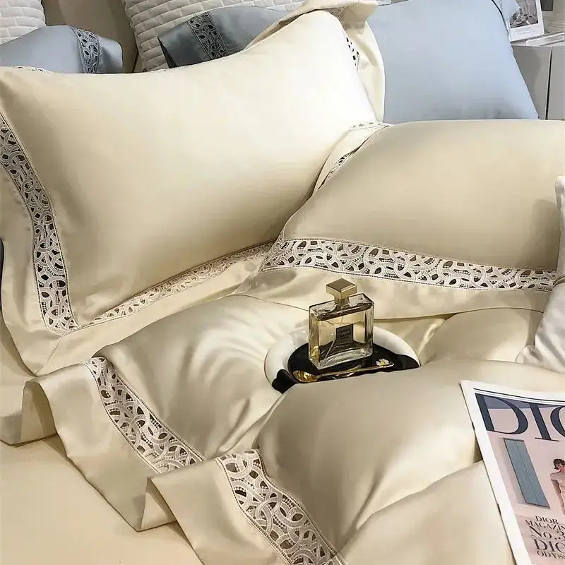 Cream-colored satin bedding set with delicate white lace trim made from decorbites eucalyptus fiber for luxury bedroom use
