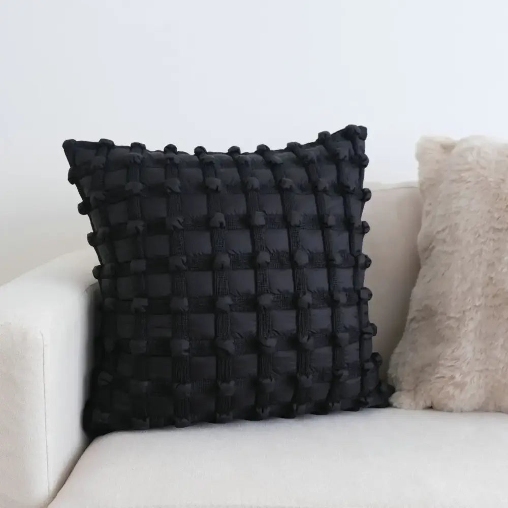 Black woven cushion cover with textured grid pattern and pom pom accents for decorbites cream white plaid decor