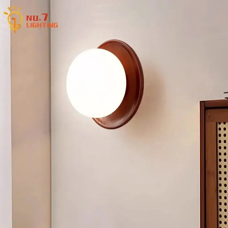 Warm-toned decorbites cream wind dumplings wall light with matte white glass globe and rich brown wooden frame for bedroom decor