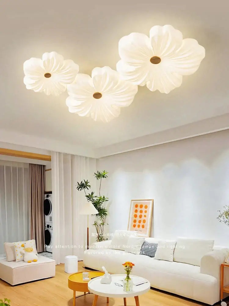 Three white flower-shaped cream wind eye ceiling lights with soft glowing centers for living room decorbites cream wind