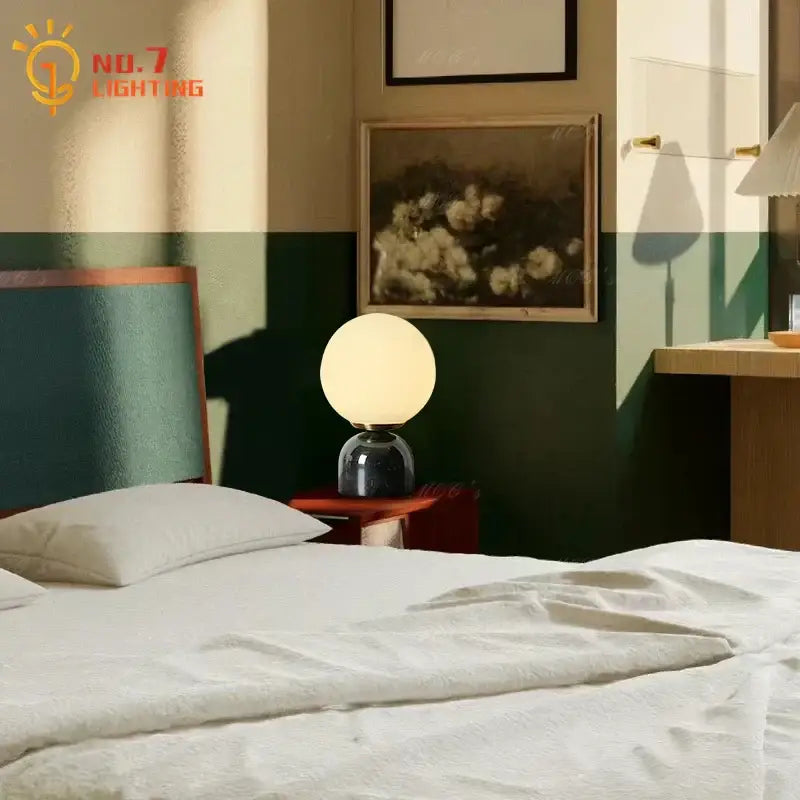 Cream wind marble table lamp with warm-toned spherical glass and dark glossy base ideal for bedroom decorbites cream wind