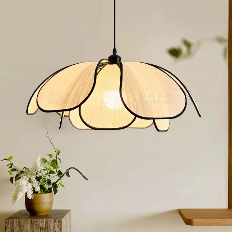 A creamy abaca fabric pendant light with black-trimmed petals by decorbites for dining room decor