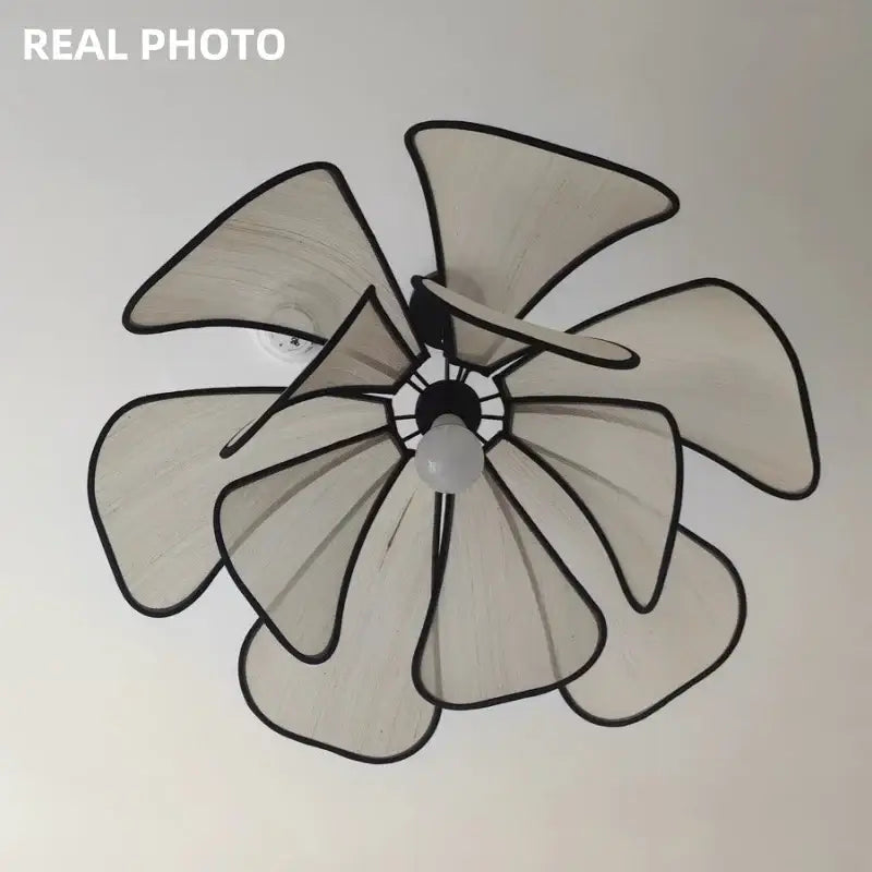 A modern pendant light with six light beige translucent petal-shaped blades outlined in black for dining room decorbites creamy abaca fabric