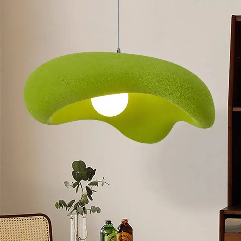 A vibrant lime green plush-textured creamy style pendant light with an organic leaf-like shape for dining room decor