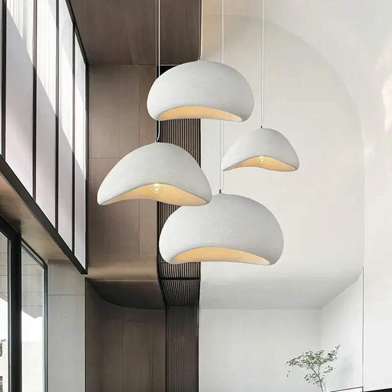 Modern white ceramic creamy style wabi sabi pendant lights with warm glowing interiors for stairs and living room decorbites